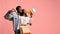 Excited black couple shopaholics with purchases and megaphone, copy space