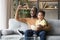 Excited black father with toddler son watching sport tv game