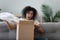 Excited black girl feel overjoyed opening package at home