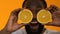 Excited black man holding fresh orange halves, shocked by energetic nutrition?