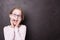 Excited blond child girl kid at the chalkboard blackboard