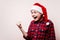 Excited boy in christmas hat making win gesture