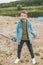 excited boy in denim jacket holding baseball bat and looking