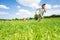 Excited boy runs away from his mates in field