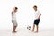 Excited boy showing wow gesture while looking at brother playing with soccer ball