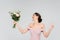 excited bride holding wedding bouquet and