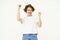 Excited brunette girl, student winning prize, celebrating victory, triumphing, standing in white t-shirt and jeans over