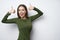 Excited brunette woman giving double thumb up