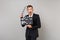 Excited business man keeping mouth wide open, looking surprised hold classic black film making clapperboard isolated on