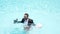 Excited business man in suit jump in swim pool water. Funny business man in suit swim in swimming pool and holding the