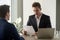 Excited businessman looking amazed while reading document, impre