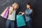 Excited casual girls with shopping bags