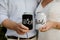 Excited Caucasian Bride & Groom Posing while Showing Off Custom Black and White Drink Beverage Koozies on their Big Wedding Day