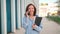 Excited caucasian businesswoman standing near office building have phone conversation feeling surprised Happy female