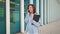 Excited caucasian businesswoman standing near office building have phone conversation feeling surprised Happy female