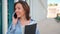 Excited caucasian businesswoman standing near office building have phone conversation feeling surprised Happy female