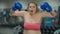 Excited Caucasian overweight woman looking at camera gesturing in boxing gloves. Portrait of motivated plus-size