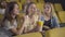 Excited Caucasian woman eating popcorn and discussing comedy with friends. Portrait of cheerful young women watching