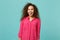 Excited cheerful mulatto african american girl in casual clothes looking camera isolated on blue turquoise wall