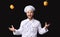 Excited Chef Guy Juggling Food Standing On Black Background