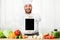 Excited Chef Man Holding Tablet Showing Blank Screen Standing Indoor