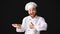 Excited Chef Showing Chicken Dish Gesturing Thumbs-Up, Black Background, Panorama