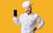 Excited Chef Showing Mobile Phone Empty Screen On Yellow Background