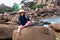 Excited child with a hat gesturing, enjoying fun outdoors activity