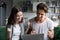 Excited couple ecstatic by online win looking at laptop screen