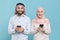 Excited couple friends arabian muslim man wonam in keffiyeh kafiya ring igal agal hijab clothes isolated on blue