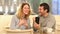 Excited couple reading good news on mobile phone