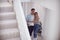 Excited Couple Standing And Hugging In Hallway Of New Home On Moving Day