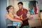 Excited couple stands at the door of a new apartment