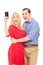 Excited couple taking a selfie with mobile phone