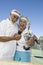 Excited Couple With Trophy Taking Self-Portrait At Tennis Court