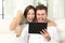 Excited couple winning online with tablet