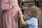 Excited curious boy applying stethoscope to pregnant mom belly