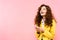 Excited curly girl using smartphone, isolated