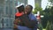 Excited dad and graduating son hugging outdoors, study achievement, education