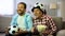 Excited dad and son cheering for favorite football team, watching game on tv