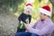 Excited Daughter Giving Father A Christmas Gift Outdoors