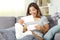 Excited disabled girl reading a paper letter at home