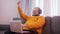 Excited elderly man with headset gambling online and winning