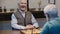 excited elderly man laughing near chessboard