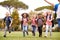 Excited Elementary School Pupils Running Across Field At Break Time