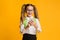 Excited Elementary Student Girl Using Smartphone Doing Homework, Studio Shot