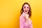 Excited face surprised girl dressed casual isolated in yellow studio. Kazakh woman shows finger on inscription, free copy space fo