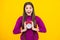 Excited face. Teen student girl hold clock  on yellow background. Time to school. Teenager child with alarm