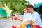 Excited family feeding colorful pigeons on animal farm