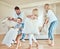 Excited family having a pillow fight. Caucasian family playing with pillows. Happy children pillow fighting with parents